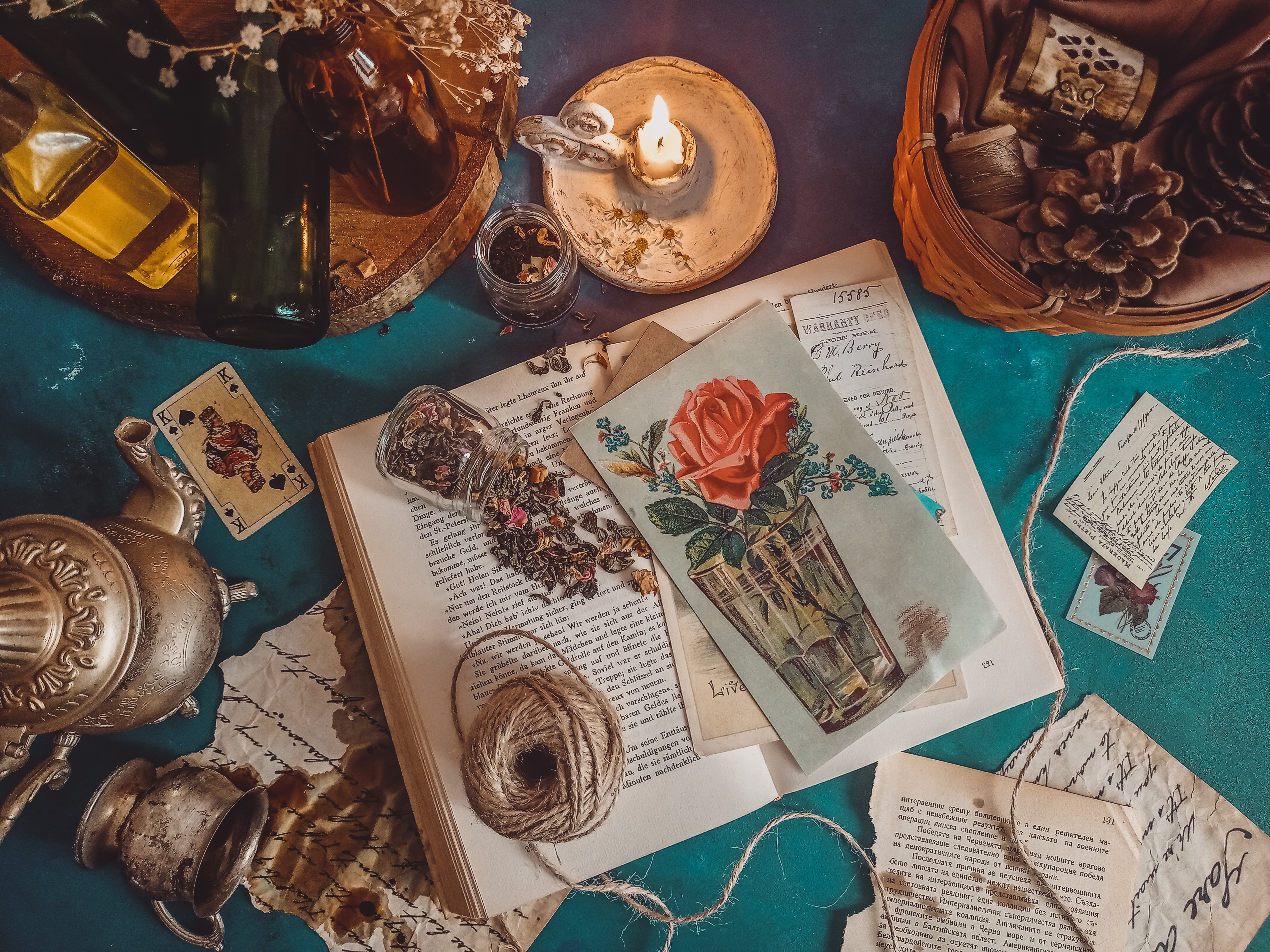 candles-books-bottles-clutter-on-table.jpg