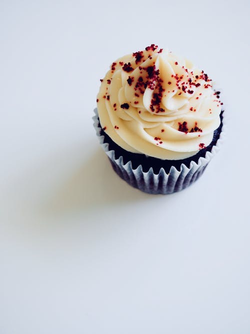 chocolate cupcake with red velvet icing and sprinkles