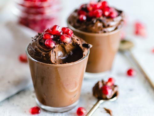 two cups of chocolate parfait with red berries